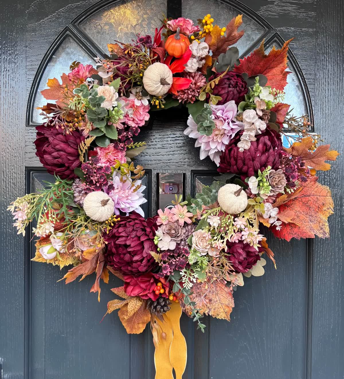 Autumn door wreath with burgundy dahlias, white pumpkins and an amber ribbon
