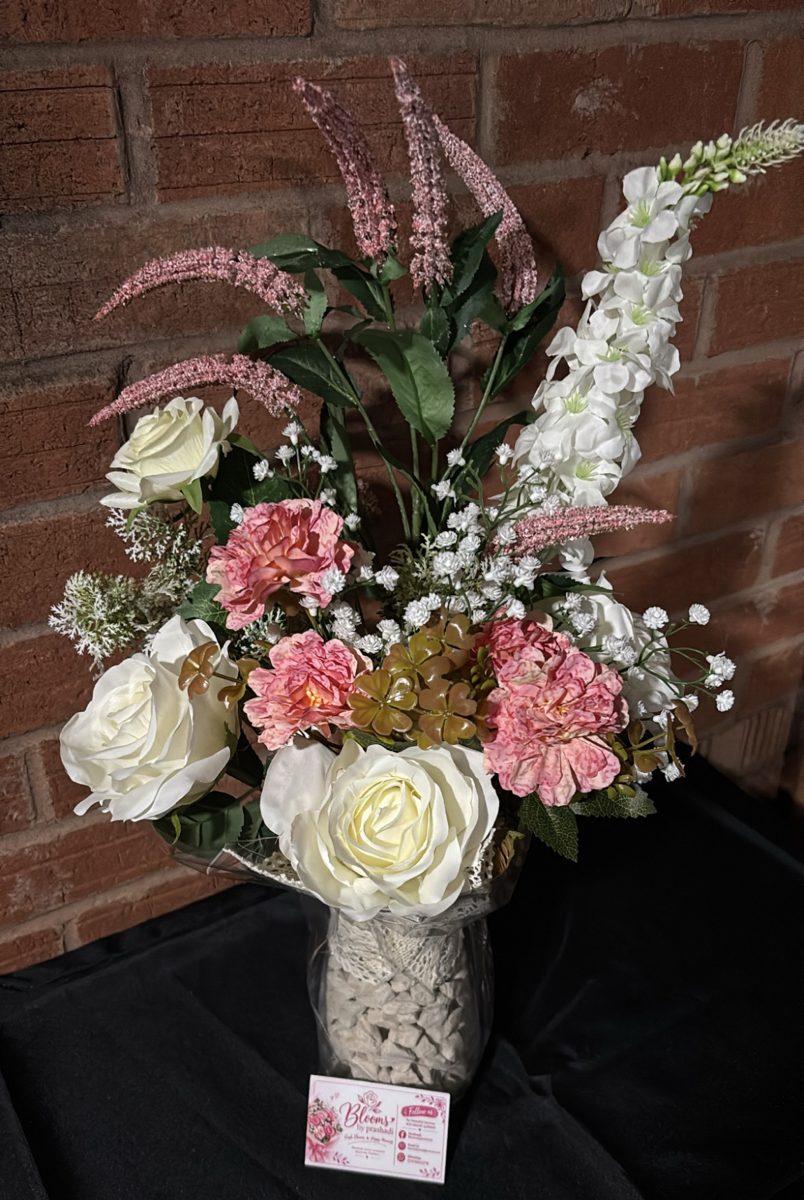 Tall vase arrangement of cream roses, pink blooms, gypsophila and white and blush stems